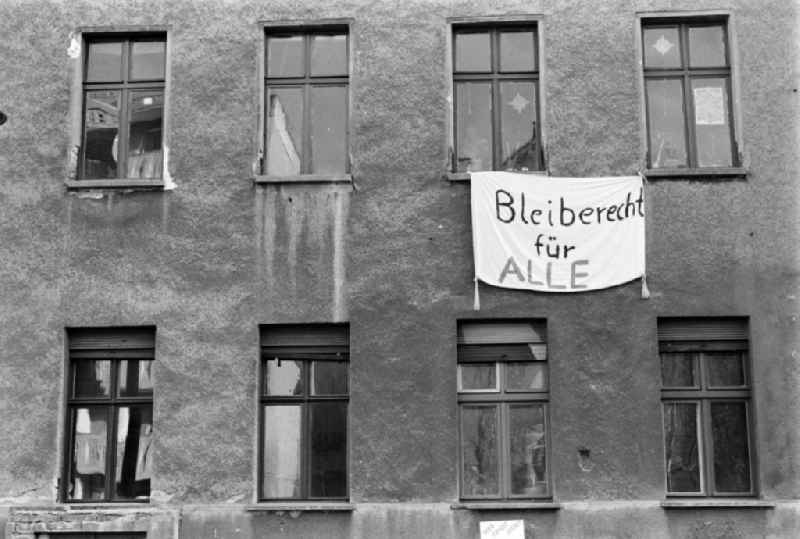 A sheet with the slogan 'Right to stay for all' hangs on a window at an occupied house in Berlin - Mitte, the former capital of the GDR, German Democratic Republic