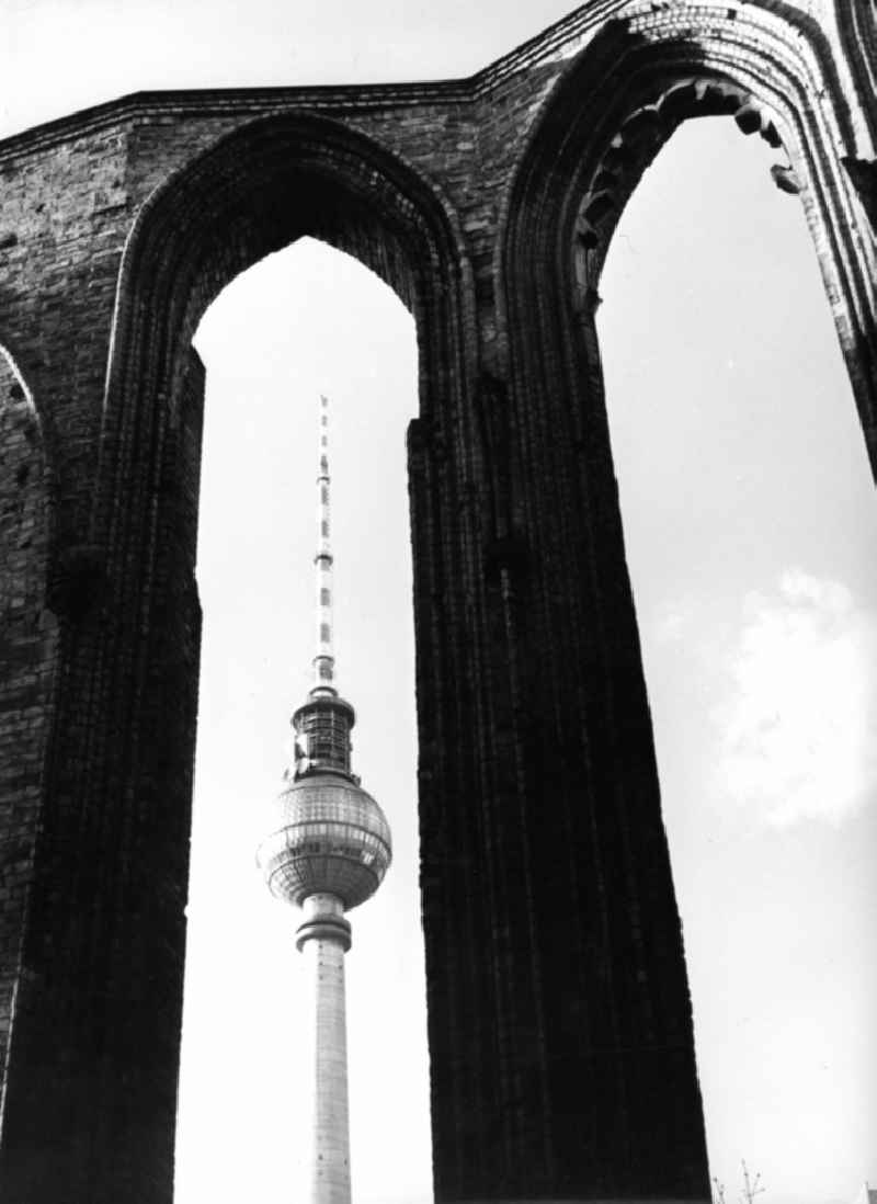 Ruins - rest of the facade silhouette and roof structure of the sacral building of the Franciscan monastery church on Klosterstrasse against the silhouette of the Berlin TV tower in the Mitte district of Berlin, the former capital of the GDR, German Democratic Republic