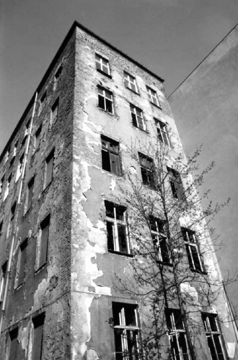 Old building - apartment building with dilapidated facade on place Kollwitzplatz in the district Prenzlauer Berg in Berlin, the former capital of the GDR, German Democratic Republic