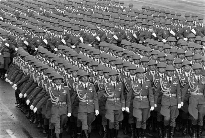 Parade formation and march of soldiers and officers on honour parade with motorised land forces units of the NVA National People's Army in Karl-Marx-Allee in the Mitte district of Berlin, the former capital of the GDR, German Democratic Republic