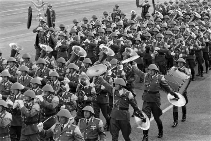Parade formation and march of soldiers and officers of the music corps on the parade of honor in the street Karl-Marx-Allee in the district Mitte in Berlin, the former capital of the GDR, German Democratic Republic