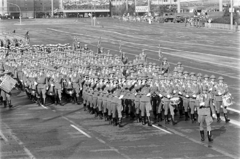 Parade formation and march of soldiers and officers of the music corps on the parade of honor in the street Karl-Marx-Allee in the district Mitte in Berlin, the former capital of the GDR, German Democratic Republic