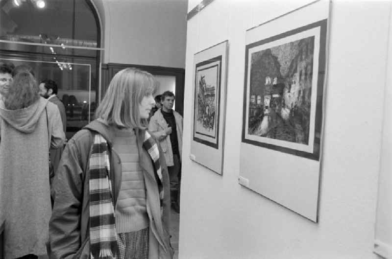 Visitors at an exhibition by Paul Kuhfuss, painter and illustrator, at Galerie a on Strausberger Platz in the Friedrichshain district of Berlin, the former capital of the GDR, German Democratic Republic