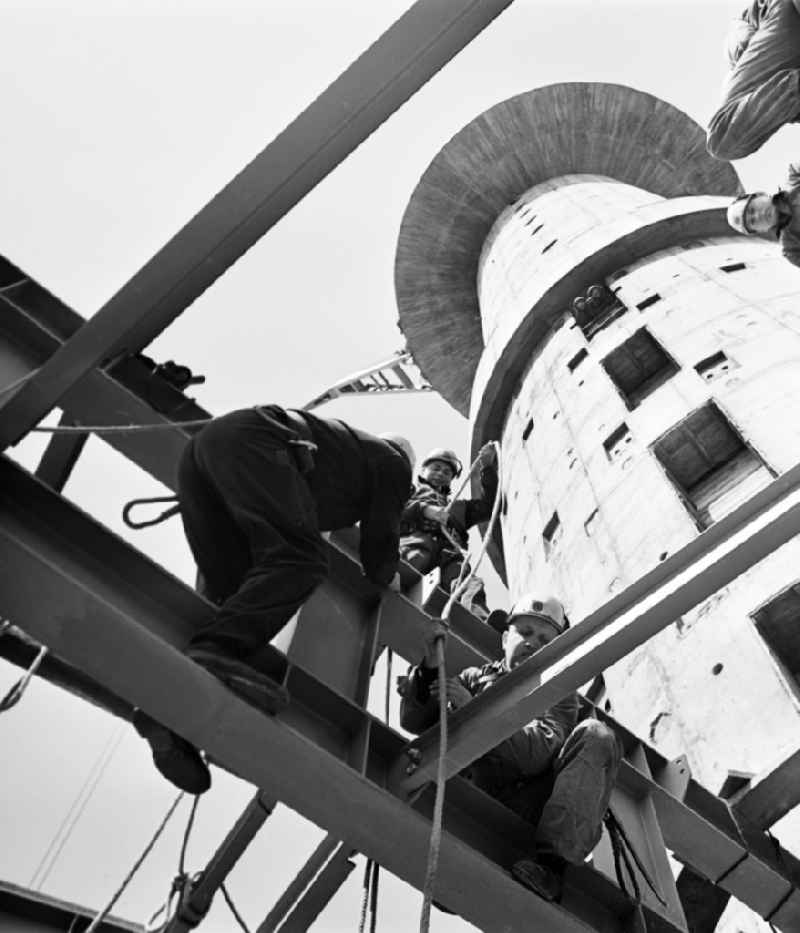 Construction workers secured with ropes and carabiners during steel girder work on the sliding core of the Berlin TV Tower in the district Mitte in Berlin, the former capital of the GDR, German Democratic Republic