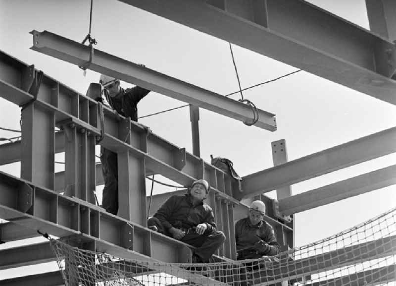 Construction workers secured with ropes and carabiners during steel girder work on the Berlin TV Tower in the district Mitte in Berlin, the former capital of the GDR, German Democratic Republic