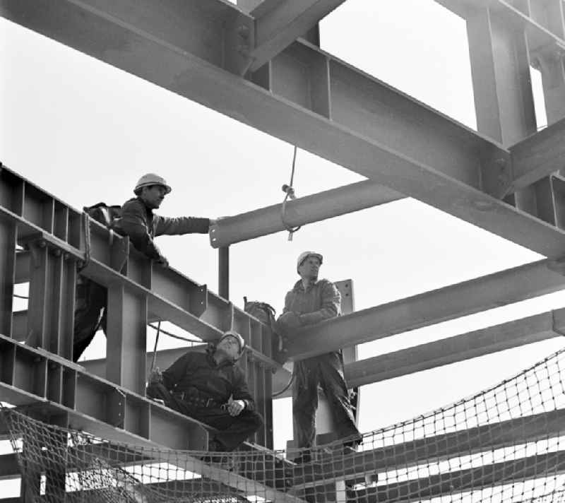 Construction workers secured with ropes and carabiners during steel girder work on the Berlin TV Tower in the district Mitte in Berlin, the former capital of the GDR, German Democratic Republic