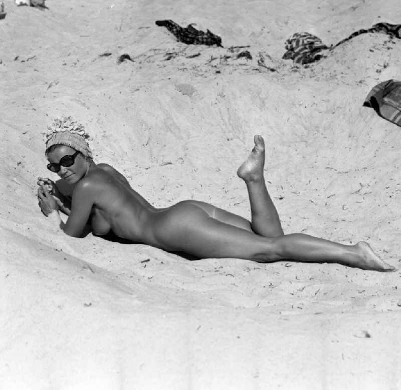 Naked young woman on a nudist beach am Langer See in Berlin, the former capital of the GDR, German Democratic Republic