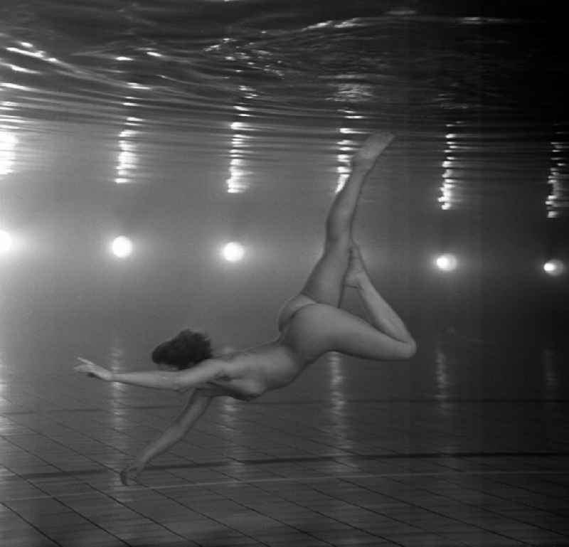 Nude of a young woman in a swimming pool in Berlin, the former capital of the GDR, German Democratic Republic