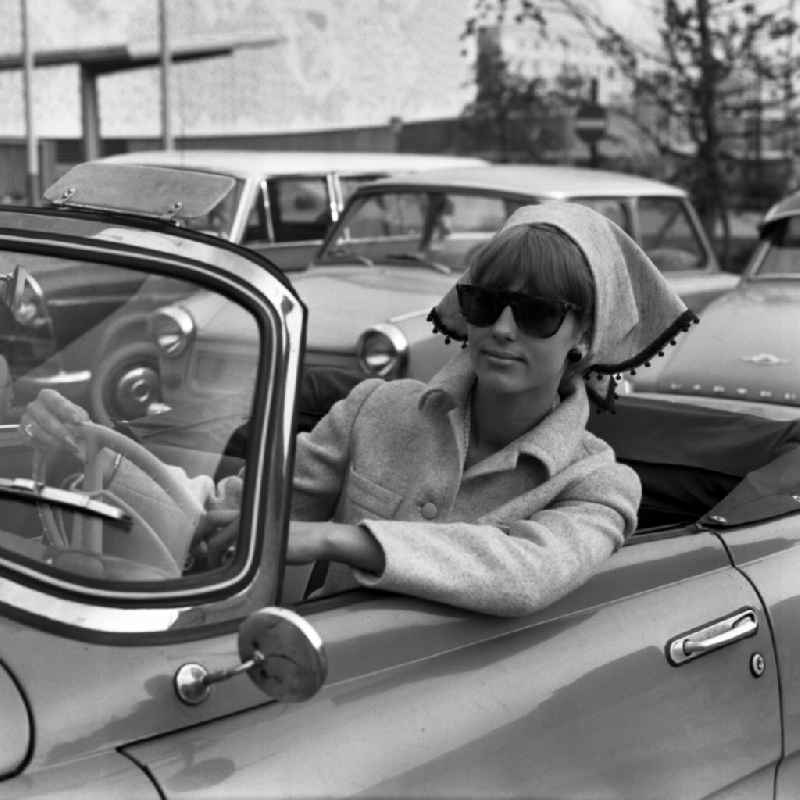 Young woman as a driver at the steering wheel of a car SKODA FELICIA Cabriolet in Berlin, the former capital of the GDR, German Democratic Republic