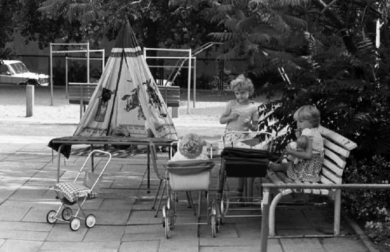 Summer temperatures while playing and having fun with toddlers cared for by educators in a kindergarten on a playground in Berlin East Berlin on the territory of the former GDR, German Democratic Republic