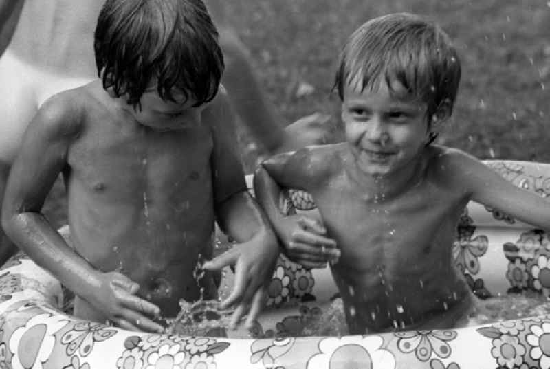 Boys bathing in a paddling pool at the kindergarten in summer in Berlin Eastberlin on the territory of the former GDR, German Democratic Republic