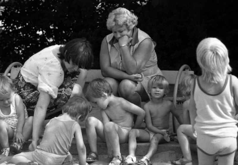 Children in the garden of the kindergarten in summer in Berlin Eastberlin on the territory of the former GDR, German Democratic Republic