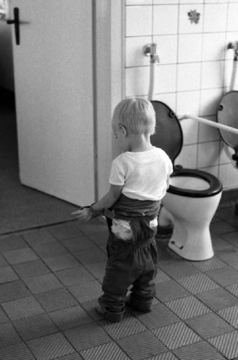 Toddler go to the lavatory in a day nursery in Berlin Eastberlin on the territory of the former GDR, German Democratic Republic