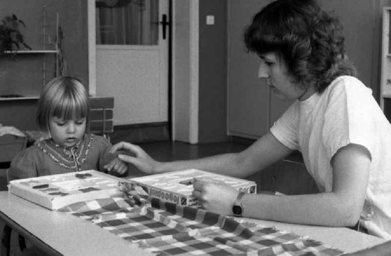 Nursery nurse plays a laying game with a little girl in Berlin Eastberlin on the territory of the former GDR, German Democratic Republic