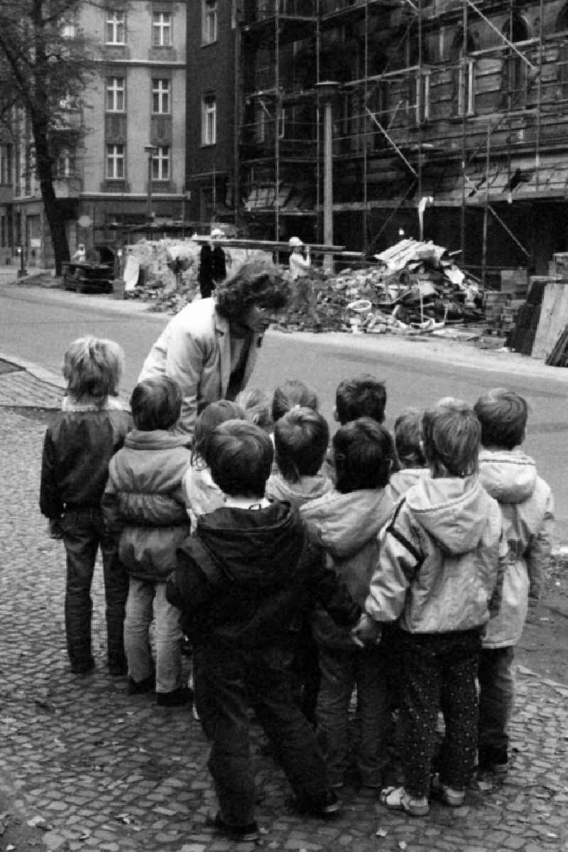 Traffic education kindergarten in Berlin Eastberlin on the territory of the former GDR, German Democratic Republic. Kindergarten teacher is standing together with children on a street, children are listening attentively