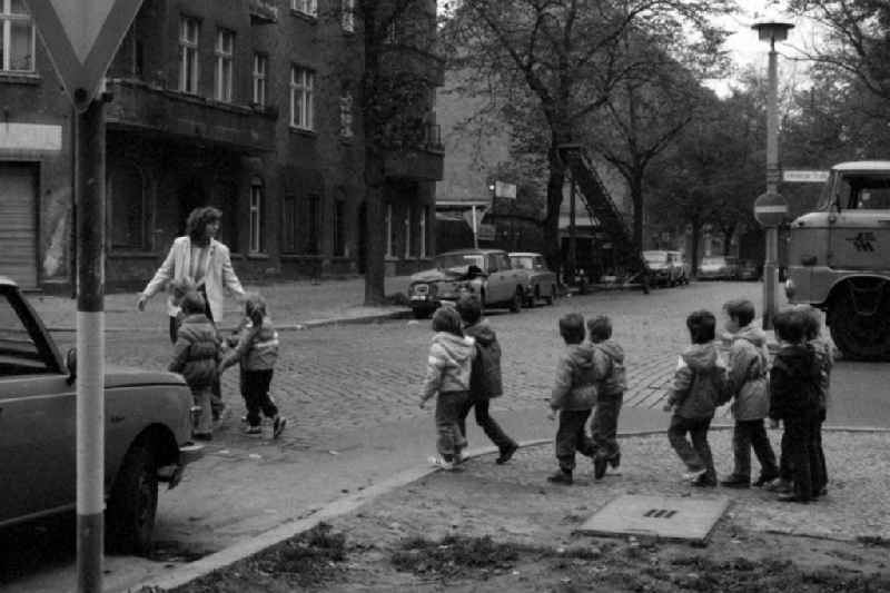 Traffic education kindergarten in Berlin Eastberlin on the territory of the former GDR, German Democratic Republic. Kindergarten teacher crossing a road with a group of children
