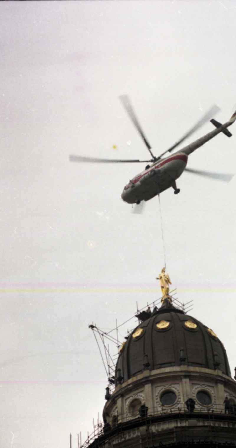 Special operation of an INTERFLUG - crane flight operation - Mi-8 helicopter to fly in the dome figure of the German Cathedral on Gendarmenmarkt in the district of Mitte in Berlin East Berlin on the territory of the former GDR, German Democratic Republic