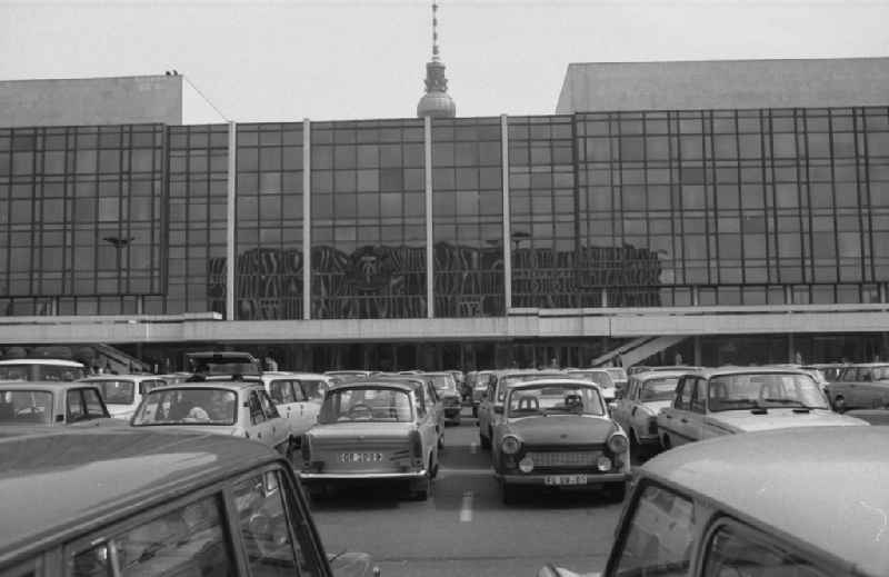 Passenger cars - Motor vehicles in a parking lot in front of the Palace of the Republic in Berlin East Berlin on the territory of the former GDR, German Democratic Republic