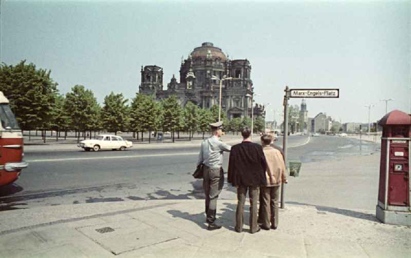 Officer in the uniform of the National People's Army shows tourists the way on the street Unter den Linden corner Marx-Engel-Platz in the district Mitte in Berlin East Berlin on the territory of the former GDR, German Democratic Republic
