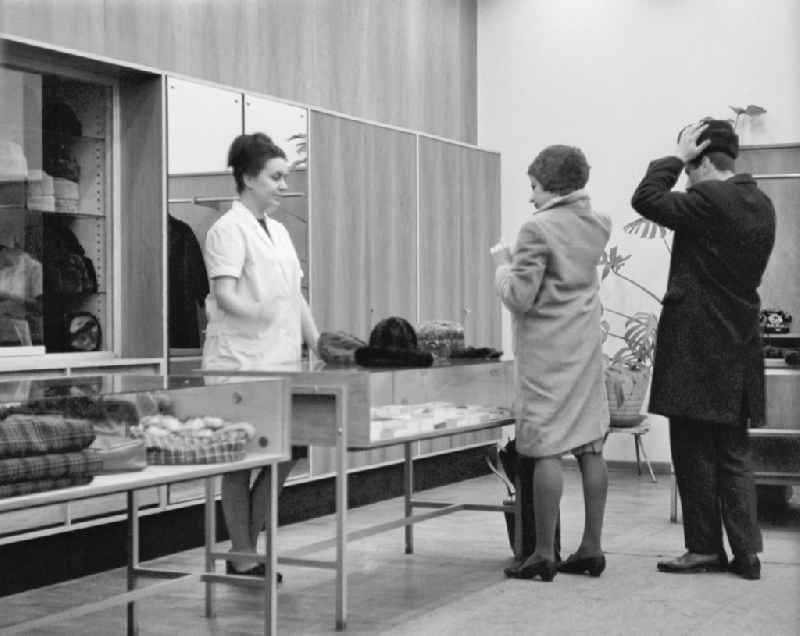 Fashion and clothing of street passers-by in a hat shop on street Friedrichstrasse in Berlin Eastberlin in DDR