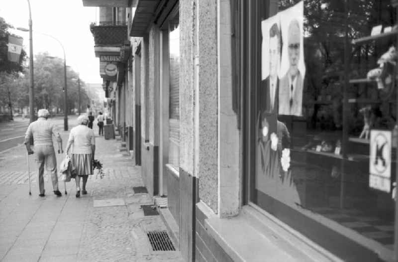 Shopping street with politicians' posters from Mengistu Haile Mariam and Erich Honecker in the shop window as propaganda for a state visit in the Friedrichshain district of Berlin East Berlin in the area of ??the former GDR, German Democratic Republic