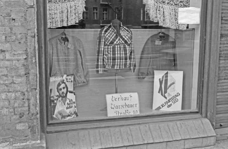 Ideologically oriented slogan and lettering and posters in a shop window in Berlin Eastberlin on the territory of the former GDR, German Democratic Republic