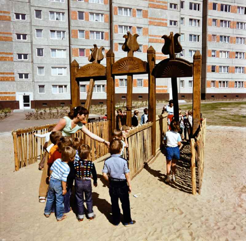 Children play on a playground in the Marzahn residential area in Berlin Eastberlin on the territory of the former GDR, German Democratic Republic