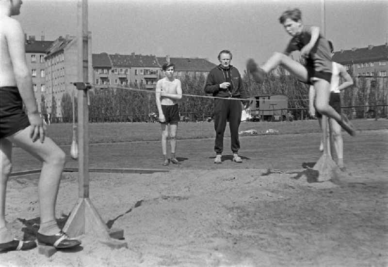 Students in physical education classon a sports field on street Guertelstrasse in the district Friedrichshain in Berlin Eastberlin on the territory of the former GDR, German Democratic Republic