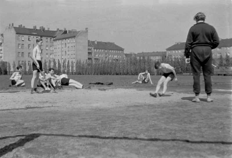 Students in physical education classon a sports field on street Guertelstrasse in the district Friedrichshain in Berlin Eastberlin on the territory of the former GDR, German Democratic Republic