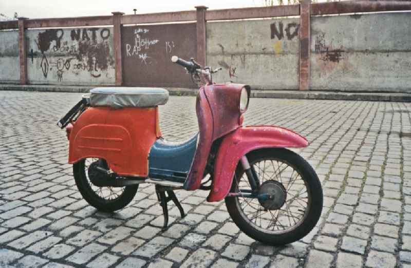 A 'Simson Schwalbe KR 51' moped - made of colorful individual parts - parked in traffic on Warschauer Strasse in the Friedrichshain district of Berlin East Berlin in the area of ??the former GDR, German Democratic Republic