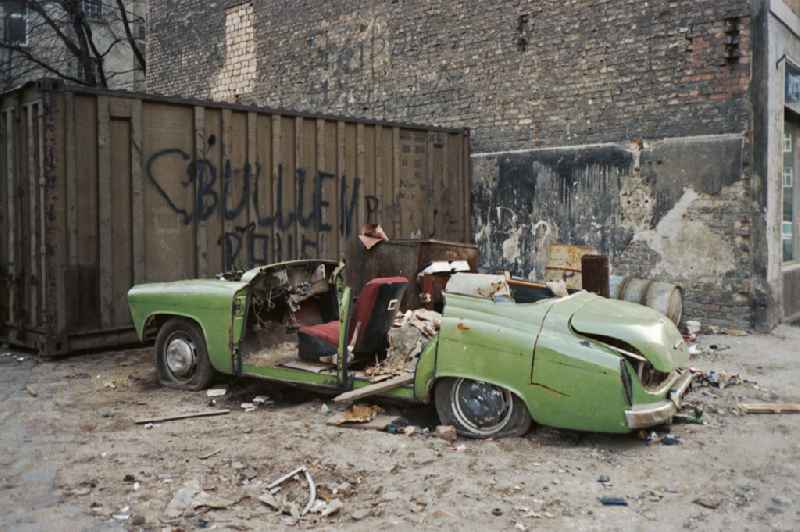 Wreck and junk debris ' Wartburg 311 ' on street Frankfurter Allee in the district Friedrichshain in Berlin Eastberlin on the territory of the former GDR, German Democratic Republic