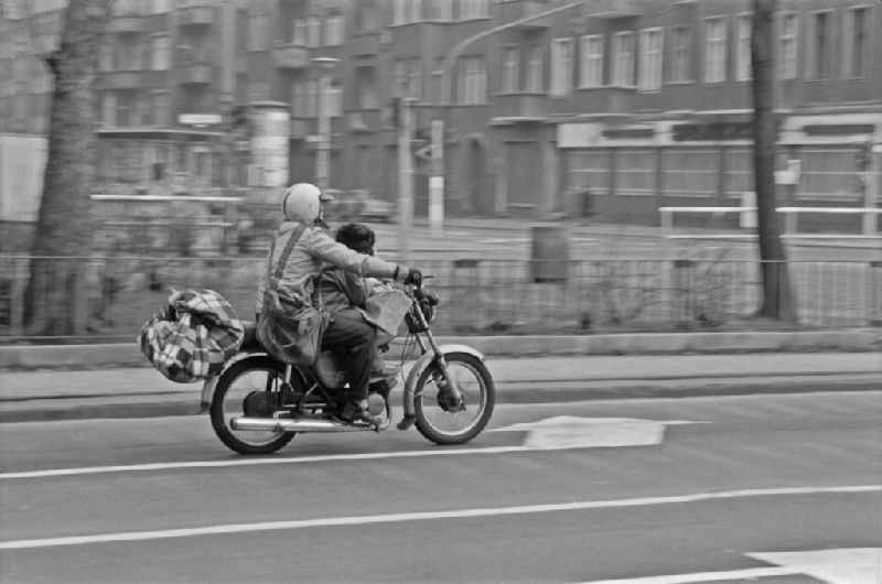 Motorcycle - motor vehicle in road traffic on street Warschauer Strasse in the district Friedrichshain in Berlin Eastberlin on the territory of the former GDR, German Democratic Republic