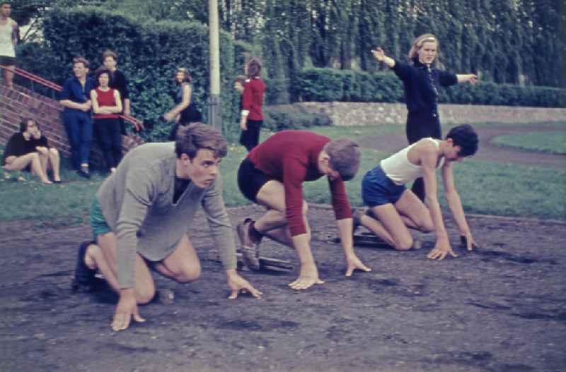 Students during physical education lessons as part of vocational training on a sports field in the Treptow district of Berlin East Berlin in the territory of the former GDR, German Democratic Republic