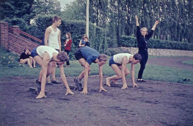 Students during physical education lessons as part of vocational training on a sports field in the Treptow district of Berlin East Berlin in the territory of the former GDR, German Democratic Republic