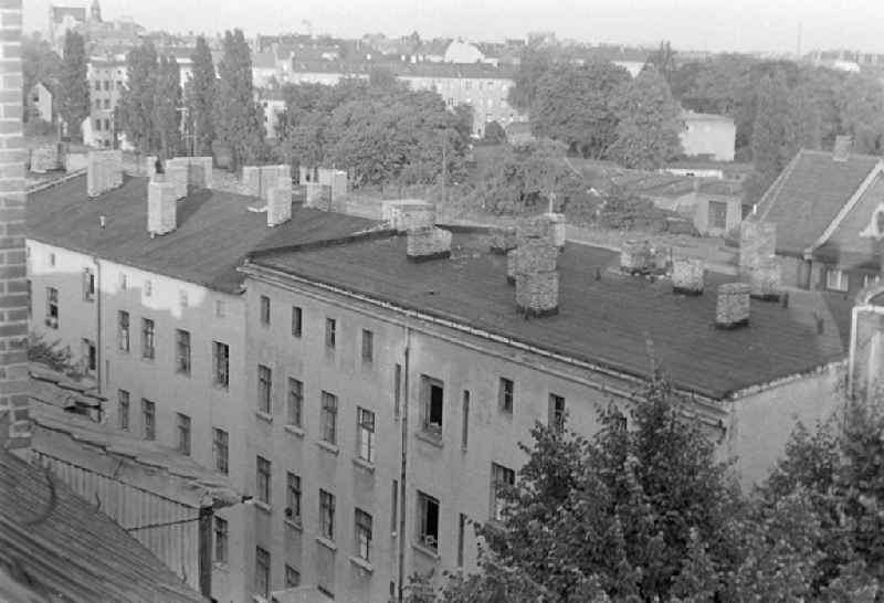 Facades of an old residential and multi-family residential building with tar paper roof and chimney ensemble on Florastrasse in the Pankow district of Berlin East Berlin in the area of ??the former GDR, German Democratic Republic