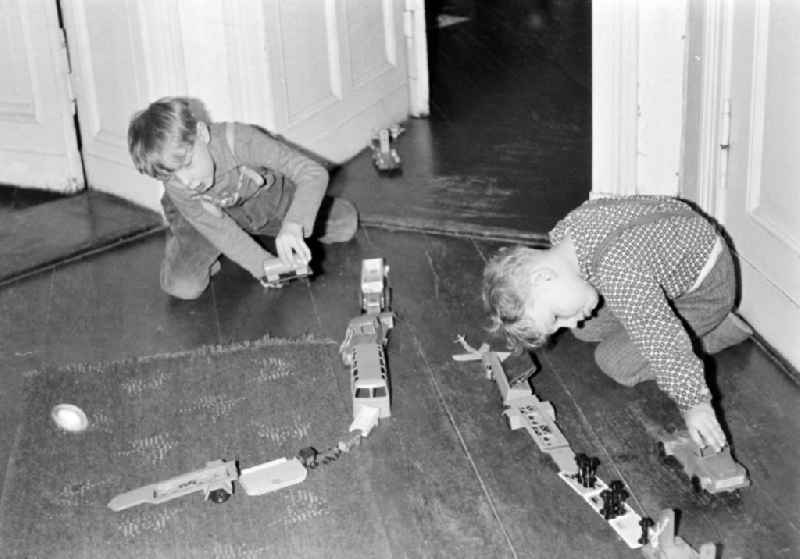 Children's play in the hallway of an apartment in East Berlin on the territory of the former GDR, German Democratic Republic