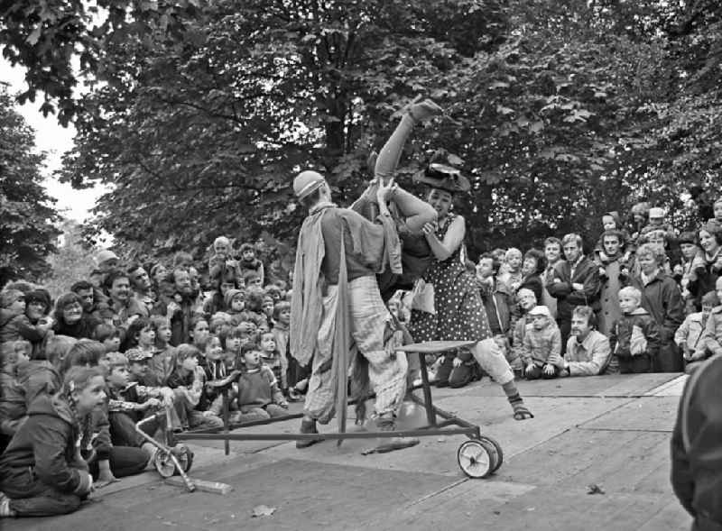 Actors and performers of a theater scene and stage design on an open-air stage on the occasion of a folk festival in the park at the Weberwiese in the Friedrichshain district of Berlin East Berlin in the area of ??the former GDR, German Democratic Republic