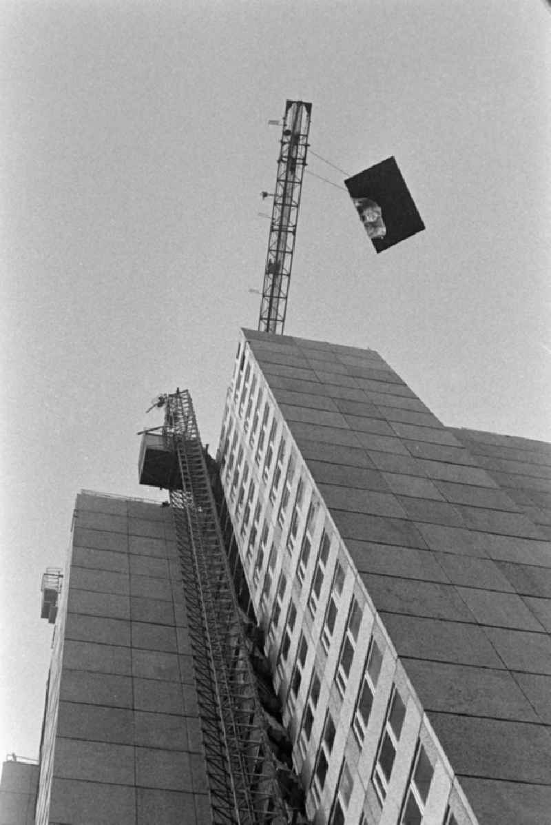 Street view of a high-rise building frontwhen installing the last panel on place Leninplatz - Platz der Vereinten Nationen in Berlin Eastberlin on the territory of the former GDR, German Democratic Republic