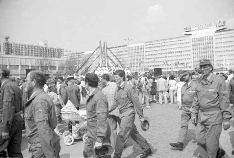 Working people and members of the uniformed combat troops leave Alexanderplatz in the city center in the Mitte district of Berlin East Berlin on the territory of the former GDR, German Democratic Republic, as participants in the May 1st combat demonstration