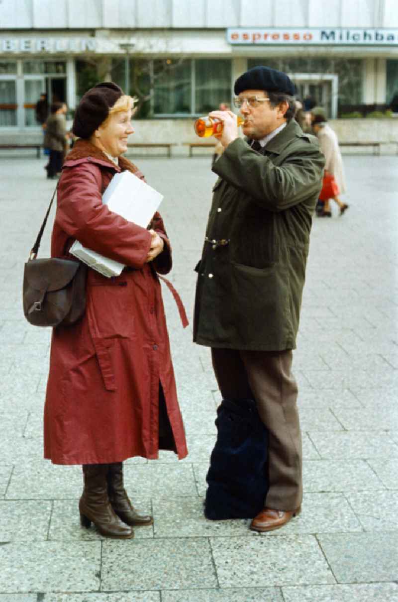 A man and a woman stand together on Alexanderplatz in Berlin-Mitte in the territory of the former GDR, German Democratic Republic
