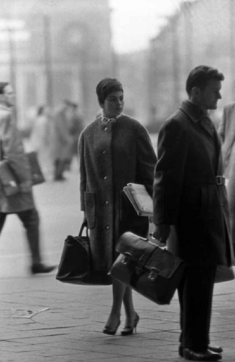 Woman shopping through the city in East Berlin in the area of the former GDR, German Democratic Republic