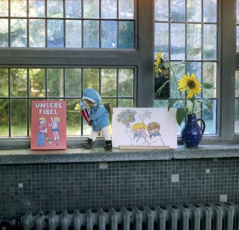 Decoration with the book 'Unsere Fibel' for school enrollment on a windowsill in Berlin East Berlin in the area of the former GDR, German Democratic Republic