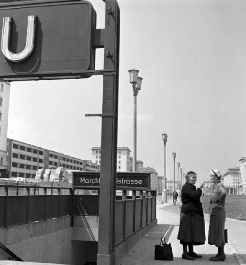 View of the newly built Stalinallee (now Karl-Marx-Allee) at the Marchlewskistrasse subway station in East Berlin in the territory of the former GDR, German Democratic Republic. Women in conversation