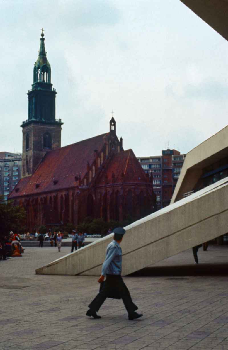 St. Mary's Church on Alexanderplatz and a policeman in East Berlin on the territory of the former GDR, German Democratic Republic
