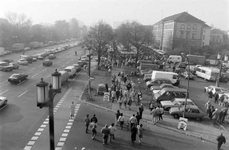 Shortly after the fall of the Berlin Wall, people from the Eastside and the Westside are walking along the road ' Strasse des 17. Juni ' in West Berlin