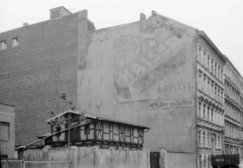 Free-standing gable wall of an old residential building facade in an old apartment building development with Kaiser briquette coal trade advertising on Schwedter Strasse in the Prenzlauer Berg district of Berlin East Berlin in the area of the former GDR, German Democratic Republic