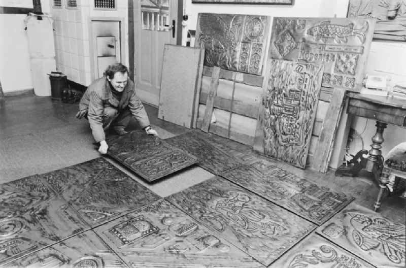 Graphic designer, stonemason and artist Robert Rehfeldt producing embossed copper reliefs for the Palasthotel in his studio in the Pankow district of East Berlin in the territory of the former GDR, German Democratic Republic