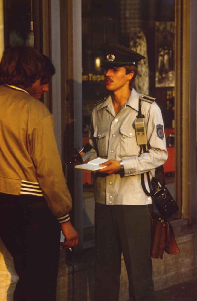 Identity check, a police officer of the People's Police questions a man in East Berlin in the territory of the former GDR, German Democratic Republic