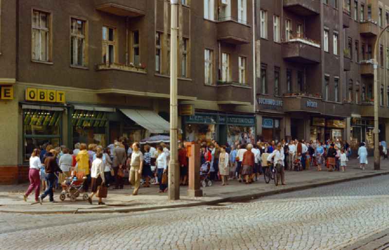 Queue of people in front of a fruit and vegetable shop in East Berlin on the territory of the former GDR, German Democratic Republic