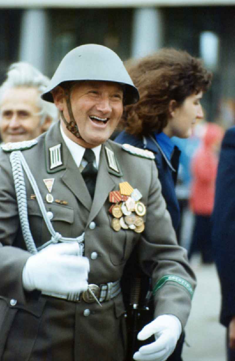 Officer of the border troops with the rank of lieutenant colonel in parade uniform with steel helmet on the Alexanderplatz in East Berlin in the territory of the former GDR, German Democratic Republic